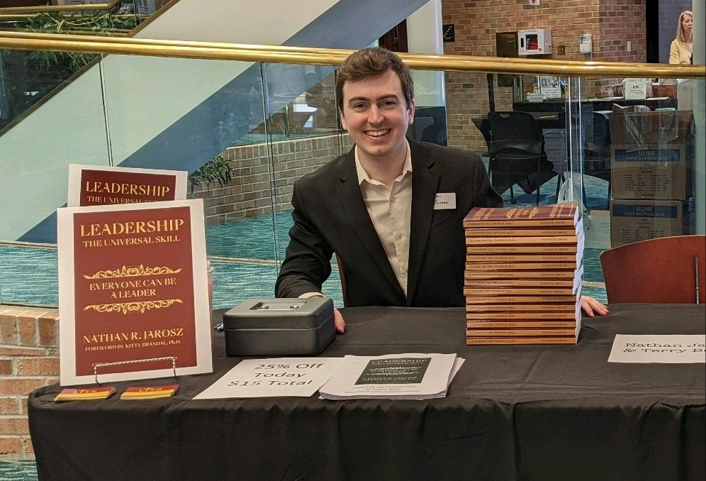 Candidate for State Representative, Nathan Jarosz, poses with his Book, Leadership The Universal Skill, at a Book Expo in Lorain County